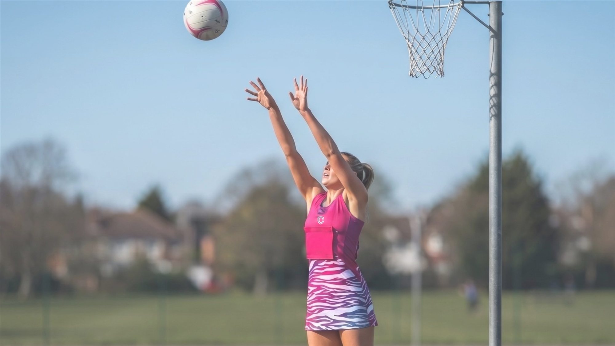 Player in match action wearing Curvo netball kit